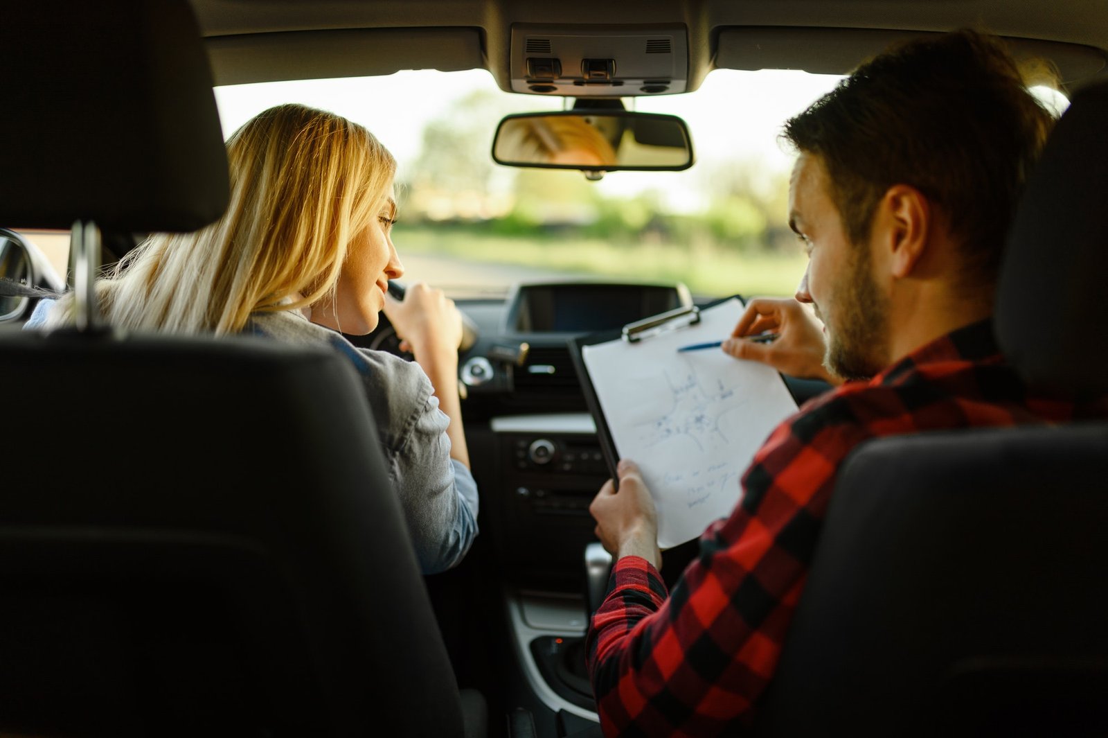 instructor-helps-woman-to-drive-the-car.jpg